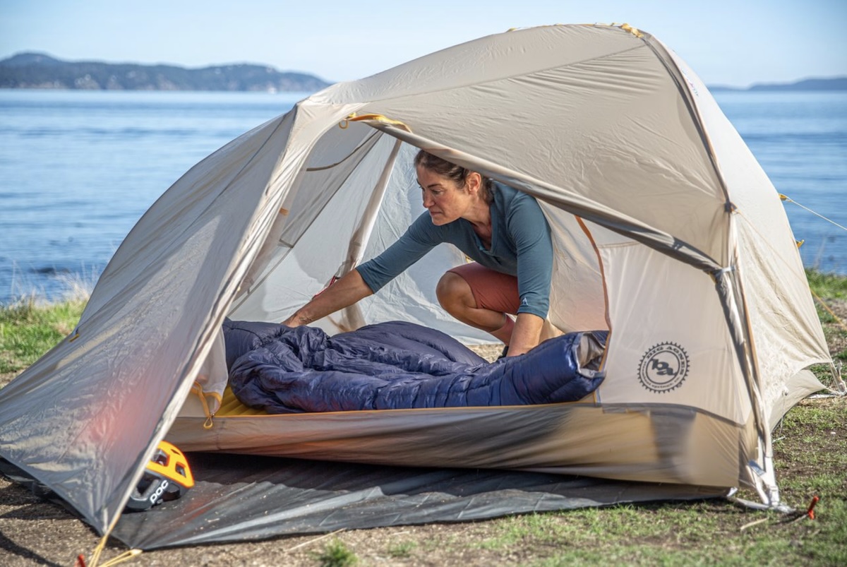 Big Agnes Tiger Wall UL 2 Bikepack capacity with a person setting up a sleeping bag 